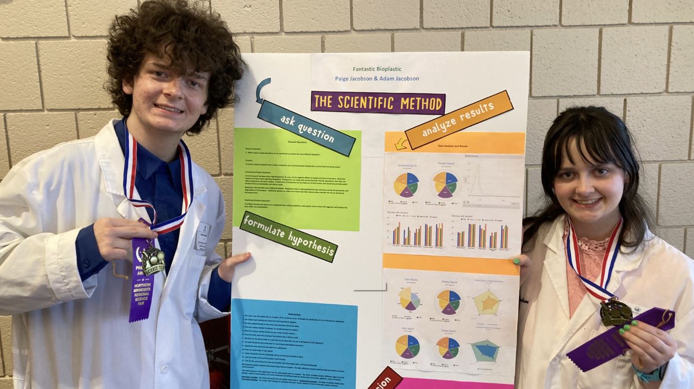 Adam and Paige Jacobson with some of their work for the Science Fair