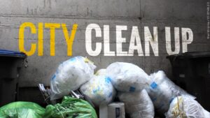 The words "City Clean Up" with trash bags