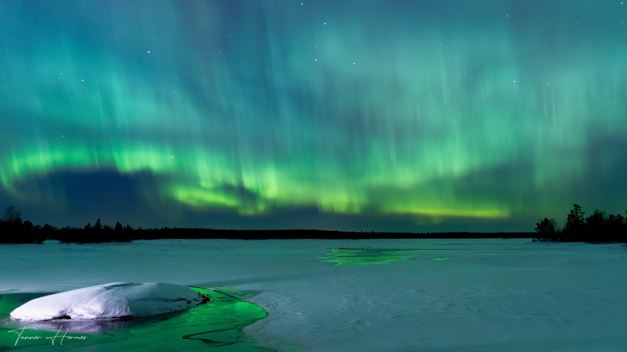 The aurora shining over a frozen lake