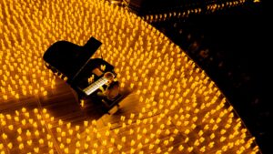 A grand piano surrounded by LED candles