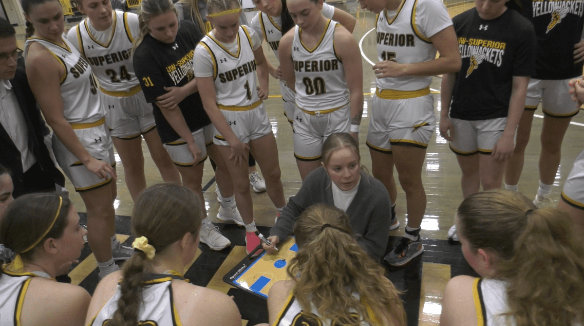UWS women's basketball coach Emily Carpenter leads a huddle during a home game against Hamline 11/20/24.